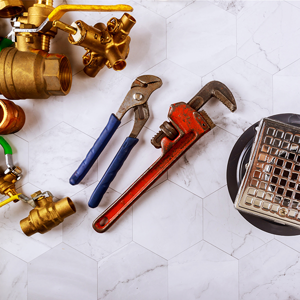 Closeup of a drain in shower room monkey wrench and plumbers fixtures Emergency Plumbing Near Me | Mr. Plumber Expert