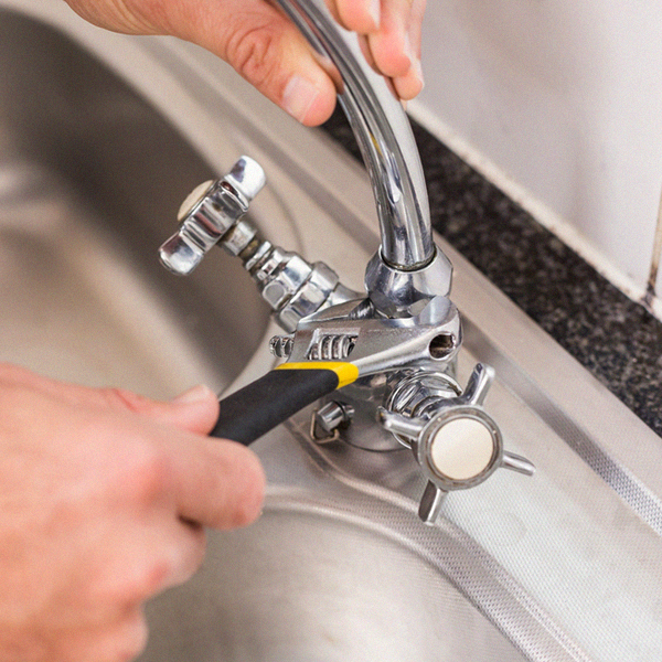 Plumber fixing the sink with wrench in the kitchen Residential Faucet Repair Service| Mr. Plumber Expert